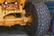 Giant Wheel tire of huge industrial mining truck on repair station. Wheel of yellow auto dumper after tyre replacement.