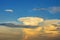 giant white cloud in the form of a mushroom in blue skies.