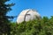 Giant white dome of the reflecting telescope covered with rust at the Observatory