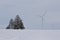 Giant wind turbines on a snow covered rural agricultural landscape