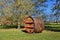 Giant wooden wine barrel with red strips painting