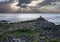 Giants Causeway, tourist silhouettes and sun beams