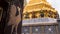 Giants statue under golden pagoda
