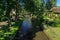 Giethoorn canal and beautiful cottages on shore.