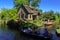 Giethoorn canal and beautiful cottages on shore.