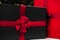 Gift black boxes with red ribbon are beautifully packaged and lie under the Christmas tree. boxes with surprises from santa claus