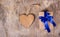 Gift box with blue bow and Valentine. Surprise on Valentine`s Day. Wooden heart. Copy space. Valentine`s day.