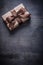 Gift box-container with brown tied bow on vintage wooden board