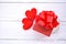 Gift box decorate with red heart on white wooden valentines day background
