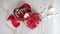 Gift box in form of heart and red ribbon on wooden white background. Top view