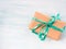 Gift box with green ribbon pastel background. Holiday present