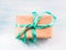 Gift box with green ribbon pastel background. Holiday present