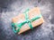 Gift box with green ribbon and snow