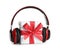 Gift box with headphones on white. Christmas music concept