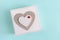 Gift box with a heart on blue background. Concept of womens day, birthday, march 8, easter, mothers day, valentines. Copy space