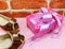 Gift box and ladies shoes on pink polka dot background