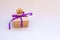 Gift box with a lilac ribbon and princess  golden crown and a bow on a gray background