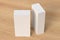 Gift box mock up: two tall and wide white boxes on wooden background.  View above