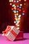 Gift box open shaped heart with Defocused bokeh colorful lights