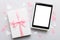 Gift box of open tablet for the holidays with a bow top view