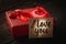 Gift box with a plastic product in the shape of a diamond on the lid of the box and a card with the words I love you