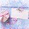 Gift box with present in form of heart, petals of sakura pink f
