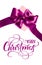 Gift box with purple bow on a white background and text Merry Christmas. lettering calligraphy