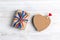 Gift box with rainbow LGBT ribbon and cork heart on a light wooden background