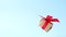 Gift box with red ribbon spinning on blue background. 360 degree rotation. zero gravity. levitation. copyspace. Concept sales, d
