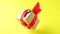 Gift box with red ribbon spinning on yellow background. 360 degree rotation. seamless loop. zero gravity. levitation. Concept sale