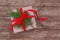 Gift box with red ribbon and sprig of coniferous tree