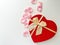 Gift box in the shape of a heart and rose petals on a light background. Gift for Valentine\\\'s Day, Mother\\\'s Day