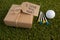 Gift box with sports equipments arranged on grass