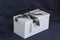 The gift box is white with a beautiful gray bow. Gift on a dark background. Holidays and surprises.