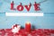 Gift box and the word love in candlelight