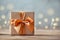 Gift box wrapped with craft paper and bow on neutral background with boke