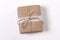 Gift box wrapped in kraft paper, decorated with cotton lace ribbon and a rope