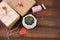 Gift boxes with cloth pegs with red hearts and succulent in concrete pot on a wooden background