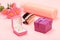 Gift boxes and cosmetics on a pink background with flowers