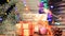 Gift boxes, decorations, burning flame sparkler and Christmas fir tree branch, garland blinking and defocused blurred lights. holi