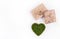 Gift boxes and a green heart. Valentine`s moss. Postcard of valentine from natural materials.