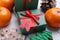 Gift boxes with paper tag and treats on white wooden background. December, 6 - Saint Nicholas Day