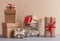 Gift boxes piles and shopping cart on wooden background