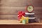 Gift boxes and watch on wooden table. New Year celebration concept