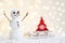 Gift card with a new year and christmas with a picture of a snowman with a sleigh against a backdrop of glowing garlands