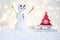 Gift card with a new year and christmas with a picture of a snowman with a sleigh against a backdrop of glowing garlands