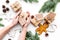 Gift exchange. Hands hold box with note Santa Secret near spruce branch and christmas cookies on white background top