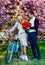 Gift with love. dog in retro bicycle date. romantic couple under sakura tree. couple in love with vintage bike. spring