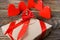 The gift is Packed in Kraft paper and tied with a red ribbon with a rose in the center of which lies a pendant