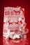 Gift packet with christmas ornaments on red background. Winter holidays.